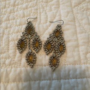 Kendra Scott gold dangle earrings with gem stone